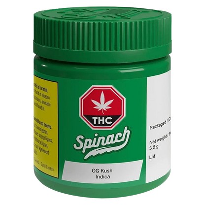 Angled front view of the green Spinach OG Kush jar with a red THC emblem and white product label visible.