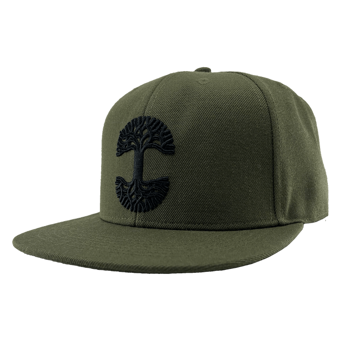The Old English Aft Snapback is an olive green hat with a flat brim, showcasing an intricate black Oaklandish tree logo embroidered on the front center. This cap features a structured crown, adjustable snapback closure, and appears new and unworn, all set against a transparent background.