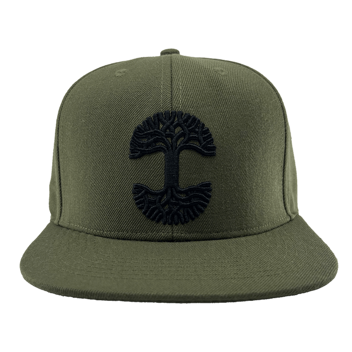 Front view of the Old English Aft Snapback by Oaklandish, an olive green hat featuring a black embroidered stylized tree with large roots and branches. The adjustable snapback cap has a flat brim, six-panel construction with stitched eyelets, and a button on top.