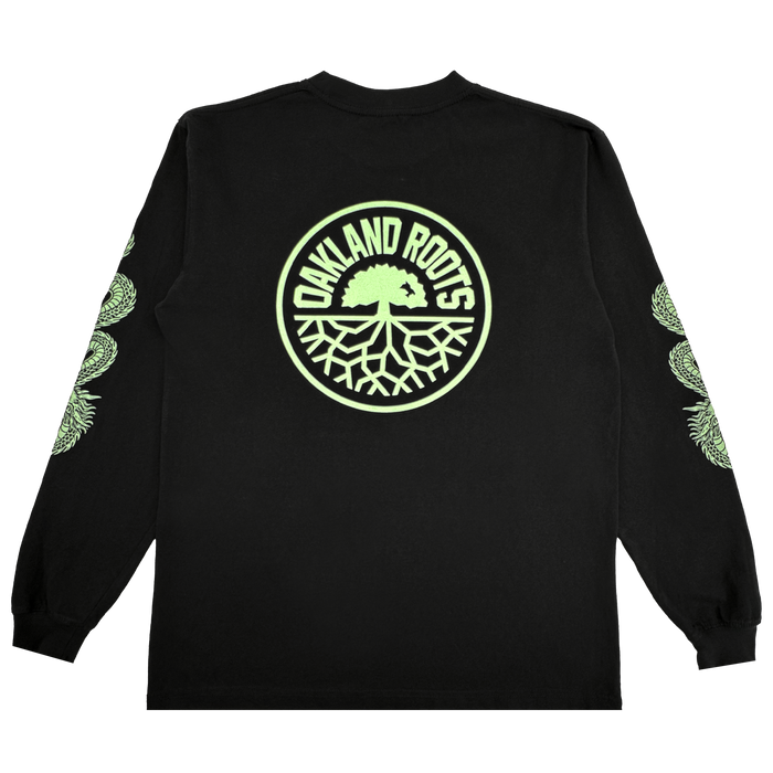 The ORSC Ryujin LS Tee by Oakland Roots SC is a black long-sleeve shirt with a large circular light green "Oakland Roots" tree logo on the back and repeating light green Roots SC tree graphics down both sleeves. Laid flat on a white background.