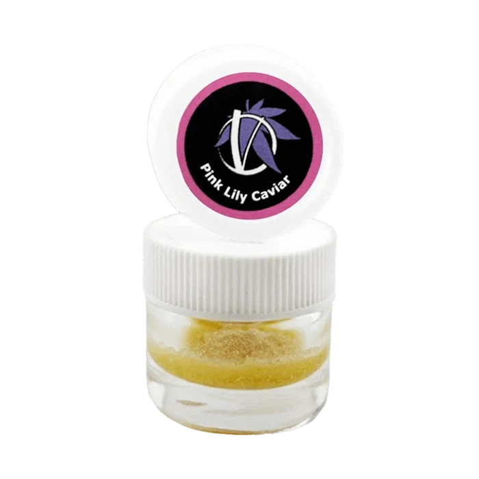 Close-up front view of a small clear jar with a white ribbed lid and open cap showing the Pink Lily Caviar logo above a golden powder inside.