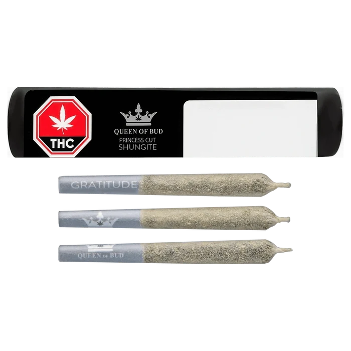Top-down view of three ash-coated pre-rolls alongside a black rectangular tube labeled "Princess Cut Shungite Infused PR 3 x 0.5 g" with a red THC stop sign and Queen of Bud logo.