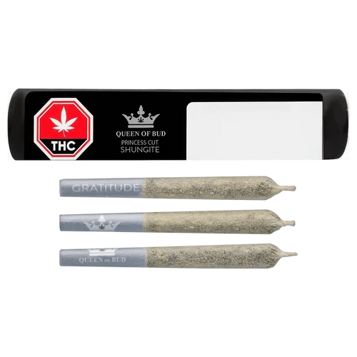 Top-down view of three ash-coated pre-rolls alongside a black rectangular tube labeled "Princess Cut Shungite Infused PR 3 x 0.5 g" with a red THC stop sign and Queen of Bud logo.