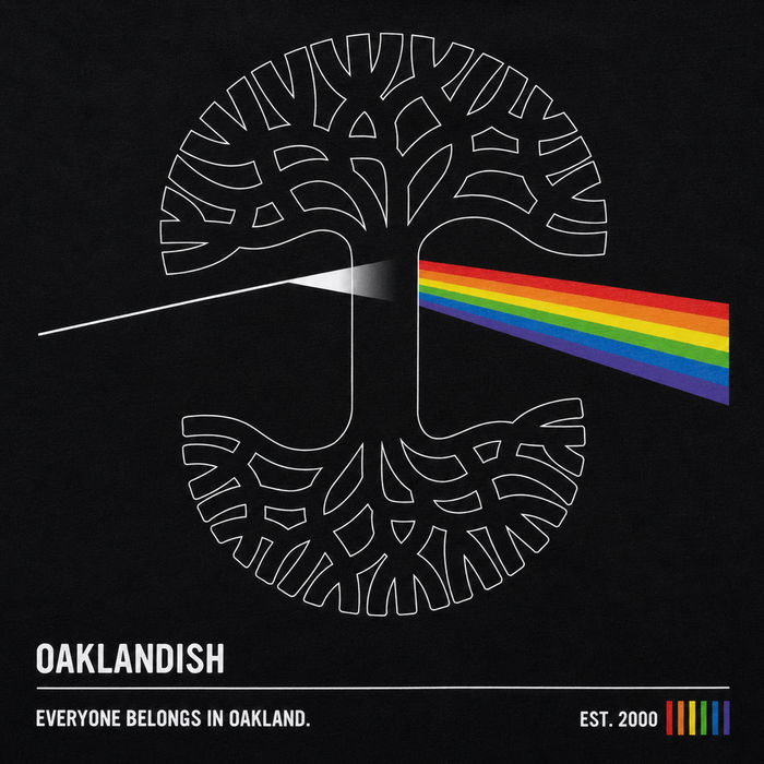 The Prismatic Tee by Oaklandish features a white tree logo with roots, a rainbow beam inspired by Pink Floyd, and “OAKLANDISH. Everyone belongs in Oakland.” Printed on a 100% cotton classic fit men's black t-shirt.