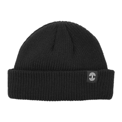 The Ramos Beanie by Oaklandish is a black knit beanie featuring a folded cuff. The cuff showcases an embroidered logo of a white tree inside a gray circular border. Made from woven acrylic, the knit pattern's texture is clearly visible, contributing to its cozy and warm appearance.
