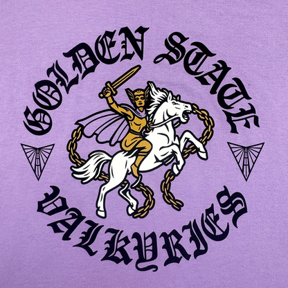 A gold-armored valkyrie on a chained white horse holds a sword aloft. “GOLDEN STATE VALKYRIES” in bold black medieval font and two geometric winged icons decorate this purple, 100% cotton ROTV Tee from GSV in a classic fit.