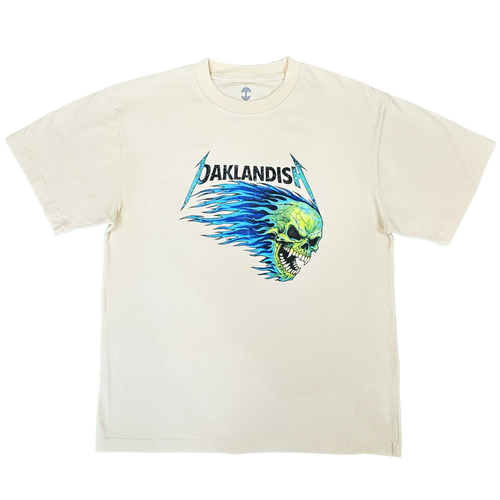 Introducing the Sandman Tee by Oaklandish: a men’s cotton t-shirt in cream, featuring “OAKLANDISH” in black, stylized lettering above a bold green flaming skull graphic with blue flames extending behind it, all centered on the chest. This classic fit tee comes with short sleeves and a simple crew neckline.