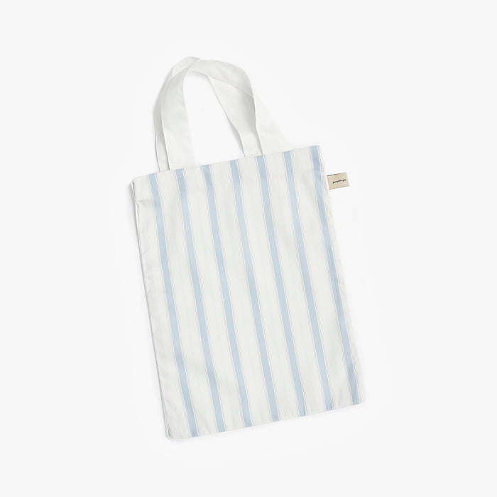 Ivory tote bag with blue stripes on a white background