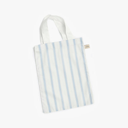 Ivory tote bag with blue stripes on a white background