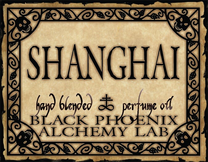 Label for 'Shanghai' hand blended perfume oil by Black Phoenix Alchemy Lab with decorative border and text.