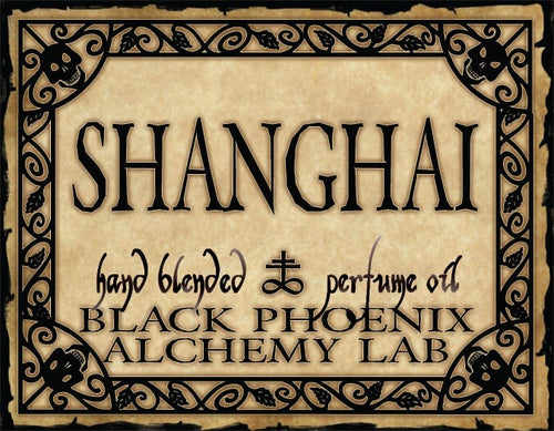 Label for 'Shanghai' hand blended perfume oil by Black Phoenix Alchemy Lab with decorative border and text.