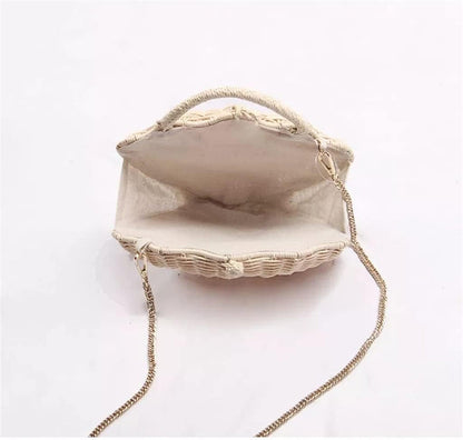 Grace Beauty shell-shaped raffia clutch handbag with woven design, crossbody strap, and pearl accents.