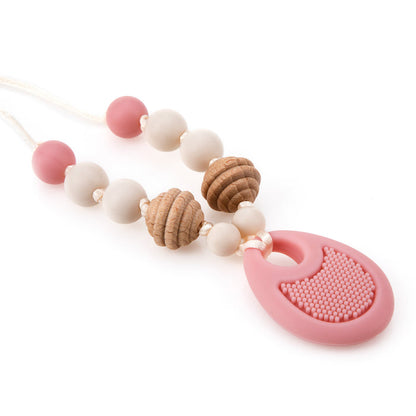 The Nuby Silicone Teething Necklace features alternating pink, white, and textured wooden beads, finished with a large, patterned silicone pendant at the bottom for soothing teething relief.