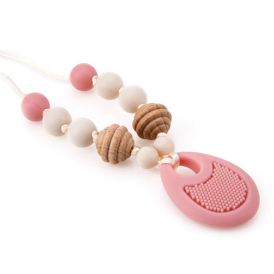 The Nuby Silicone Teething Necklace features alternating pink, white, and textured wooden beads, finished with a large, patterned silicone pendant at the bottom for soothing teething relief.