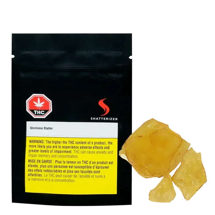 Close-up of golden-amber Slurricane Shatter, displayed against a black background with warning text and branding.