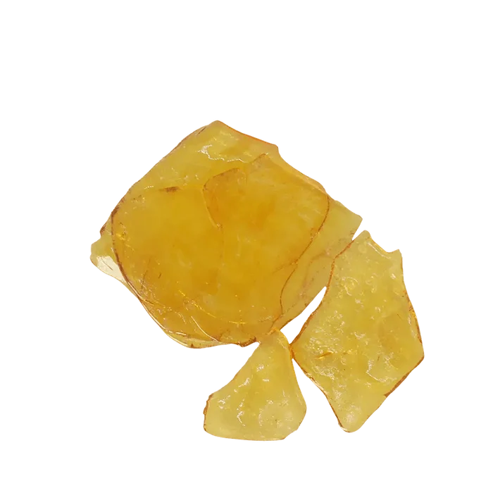 A close-up of the golden Slurricane Shatter, showcasing its translucent, fragmented texture against a white backdrop.