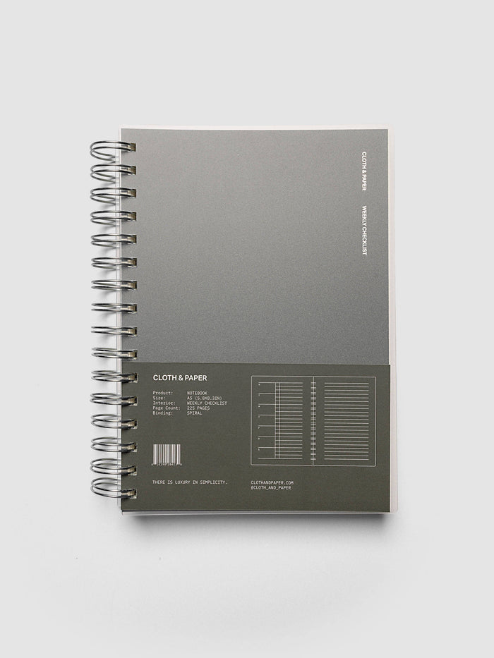 Spiral Notebook | A5 | Weekly Checklist shown closed on a neutral background, dark olive cover with a printed layout key and silver spiral binding