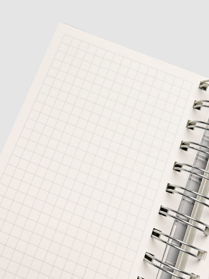 Spiral Notebook in size CP Petite with Graph Note interior showing close up of left page.