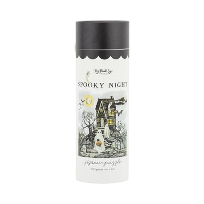 The Spooky Night | 500 Piece Jigsaw Puzzle by My Mind’s Eye comes in a cylindrical box featuring a haunted house, ghost, bare trees, full moon, and bats—ideal for spooky season fun!.