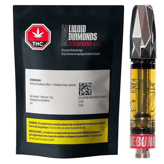 Front-lit product shot of a 1 g Strawnana Liquid Diamonds Vape Cartridge next to its black resealable pouch, showing pouch labels, THC symbol, and the cartridge’s faceted metallic mouthpiece and golden oil.