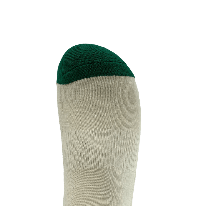 Image showing a close-up of a single foot wearing the Oaklandish Striped Classic Sock. The sock, available in adult sizes, is primarily light gray in color with a dark green toe section. Made with 70% cotton, the background is plain white, emphasizing the sock and its contrasting colors.