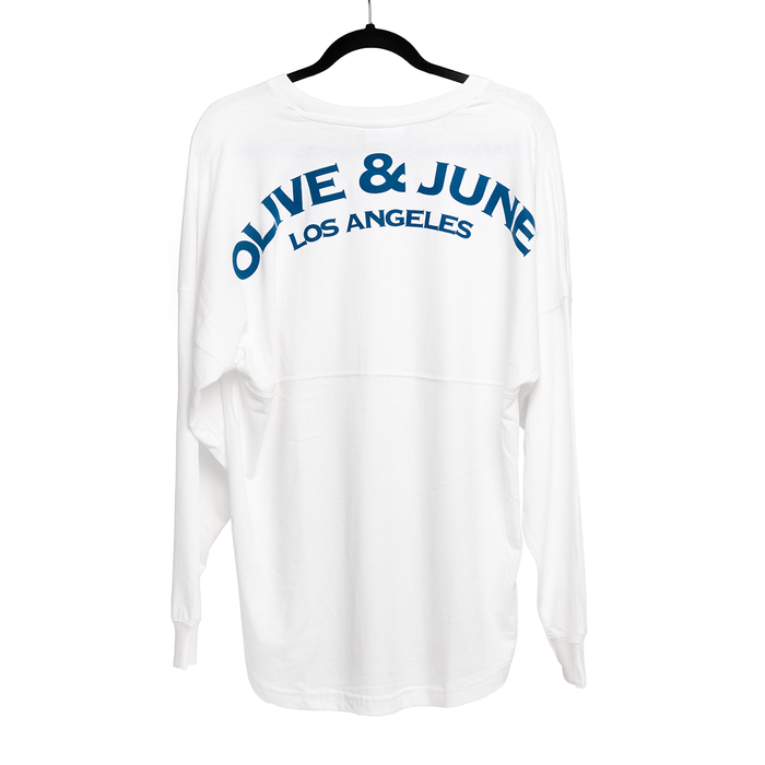 White oversized Summer Sailor Long Sleeve Shirt with blue Olive and June Los Angeles lettering on back on black hanger