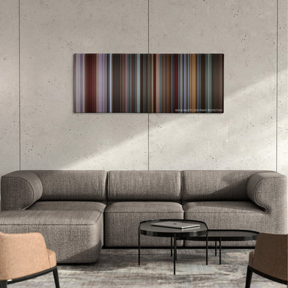 That Awkward Moment color palette canvas on a concrete wall above a gray sectional sofa