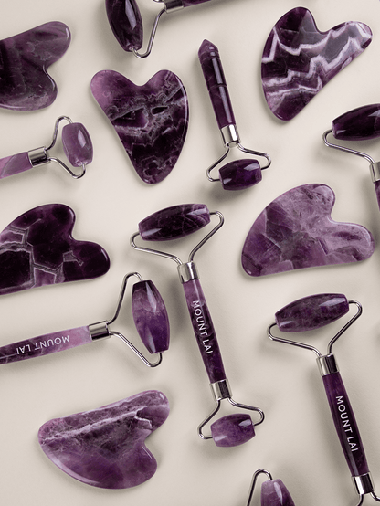 Mixed Authentic Amethyst Gua Sha Lifting Tools & Facial Rollers Laying in Collage