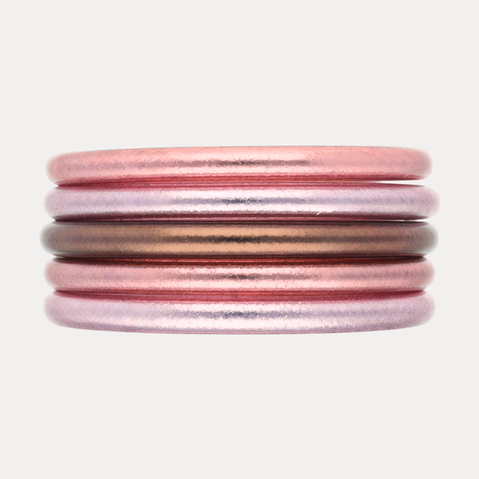 The Pink Tidal Stack features five exquisite bangles in pearlescent coastal pinks and radiant finishes.