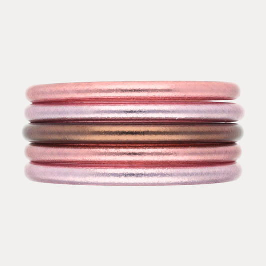 The Pink Tidal Stack features five exquisite bangles in pearlescent coastal pinks and radiant finishes.