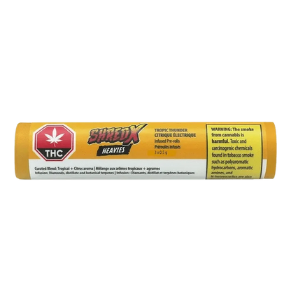 Close-up of the Tropic Thunder Heavies Infused Pre Rolled packaging, displaying bold graphics against a dark backdrop.