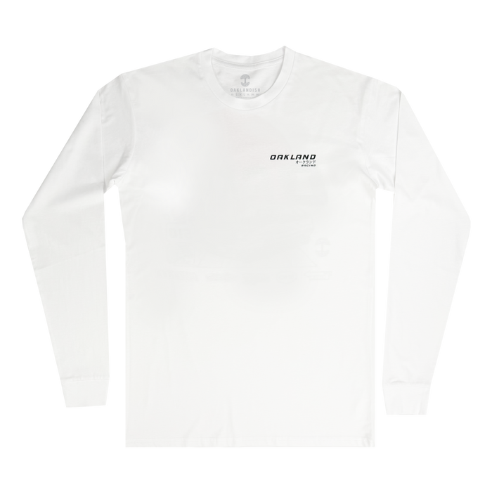 The Tuner LS Tee by Oaklandish is a classic fit, 100% cotton white long-sleeve with a minimalist design: small black text on the left chest reading "OAKLAND" and "California" beneath, set against a plain white background.