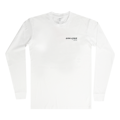 The Tuner LS Tee by Oaklandish is a classic fit, 100% cotton white long-sleeve with a minimalist design: small black text on the left chest reading "OAKLAND" and "California" beneath, set against a plain white background.