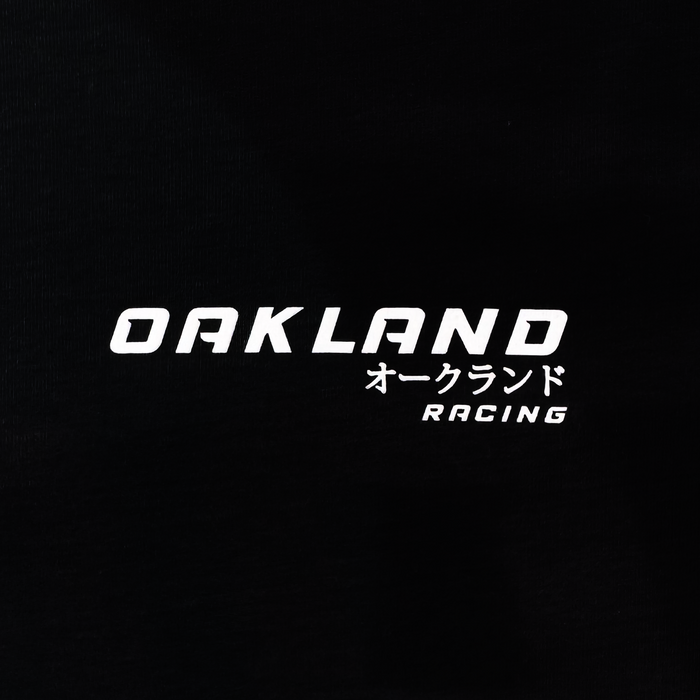 The Tuner Tee by Oaklandish is a classic fit men's 100% cotton t-shirt featuring "OAKLAND" in white text on a black background, with smaller Japanese characters and "RACING" stylishly shown underneath.