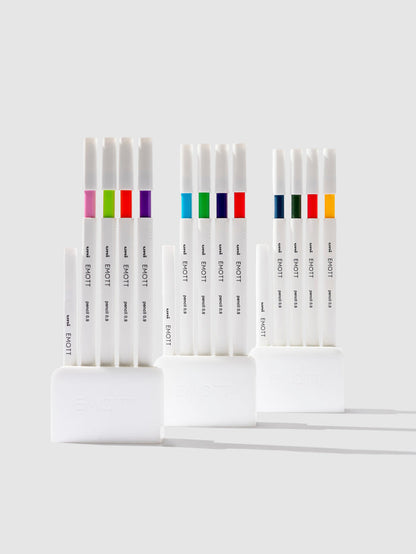 Uni Emott Colored Pencil Set, Cloth and Paper. Three sets of pens displayed on a neutral background.