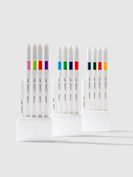 Uni Emott Colored Pencil Set, Cloth and Paper. Three sets of pens displayed on a neutral background.
