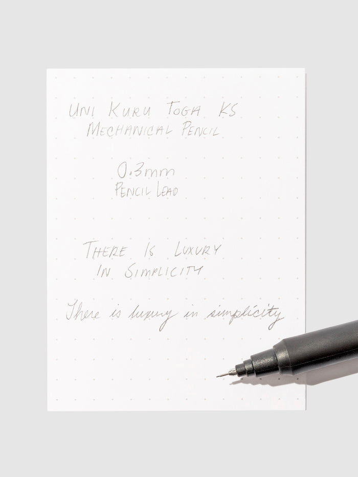 Pen testing sheet in use on a neutral background.