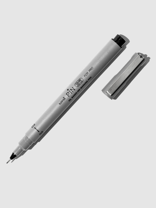 Uni Pin Marking Pen, 03, Cloth and Paper. Pen against a neutral background.