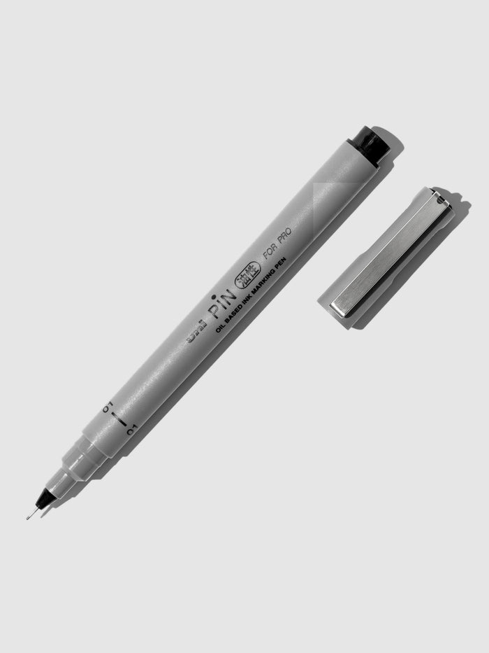 Uni Pin Marking Pen, 01, Cloth and Paper. Pen against a neutral background.
