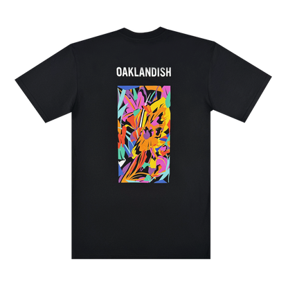 The Urban Tropics Tee by Oaklandish is a black t-shirt with "OAKLANDISH" in white near the top and Oakland artist Kalani Ware’s colorful, abstract rectangle design—featuring yellow, orange, pink, purple, blue, and green—on the back.