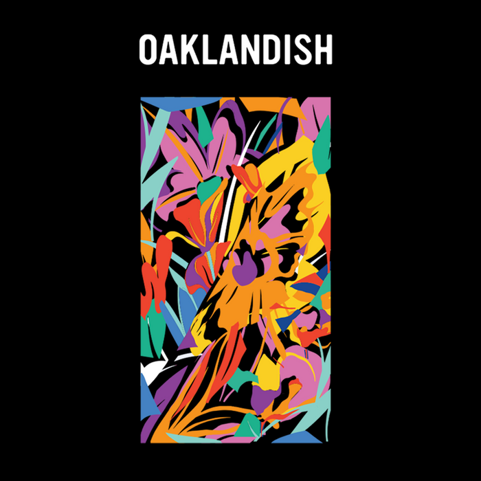 The Urban Tropics Tee by Oaklandish features bold white "OAKLANDISH" lettering above a vibrant abstract design by Kalani Ware, with overlapping jagged and curved shapes reflecting dynamic multicultural art on a black background.