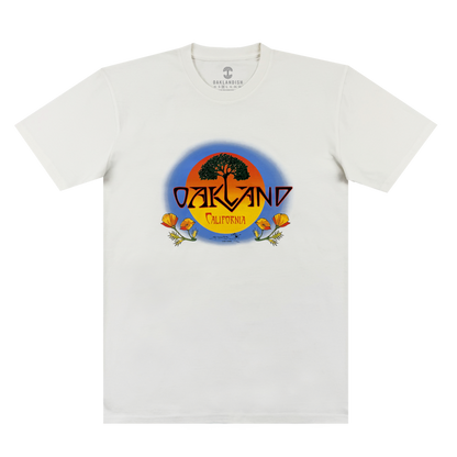 The Oaklandish Vanguard Tee is a white classic fit with an oak tree and sunset graphic. “OAKLAND” in bold yellow sits above “California,” with two orange poppies at the base. Inspired by Stanley Mouse.