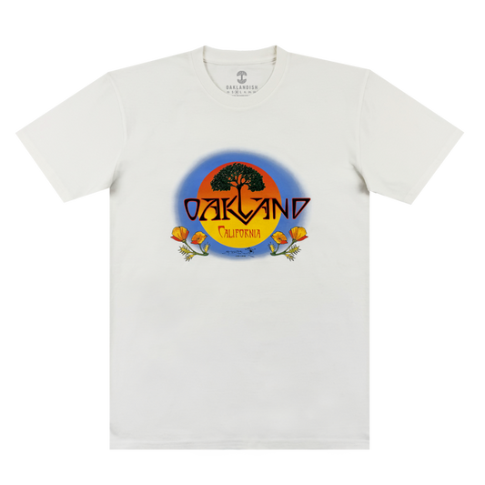 The Oaklandish Vanguard Tee is a white classic fit with an oak tree and sunset graphic. “OAKLAND” in bold yellow sits above “California,” with two orange poppies at the base. Inspired by Stanley Mouse.