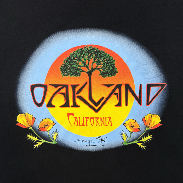 The Oaklandish Vanguard Tee features a graphic of a large tree inside an orange-yellow sun with a blue halo, "OAKLAND" and "California" text below, California poppies at the bottom, and is inspired by Stanley Mouse. Classic fit.