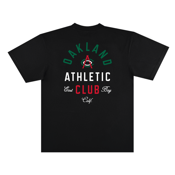 The Viva OAC Tee by OAC is a black, classic fit t-shirt crafted from heavy-weight cotton. The back showcases “OAKLAND ATHLETIC CLUB” and “East Bay Calif.” in green, white, and red fonts, highlighted by a large red “A” with a green arc centered among the text.