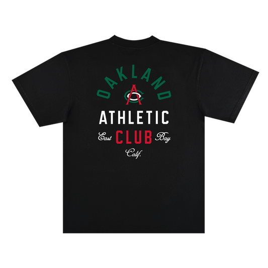The Viva OAC Tee by OAC is a black, classic fit t-shirt crafted from heavy-weight cotton. The back showcases “OAKLAND ATHLETIC CLUB” and “East Bay Calif.” in green, white, and red fonts, highlighted by a large red “A” with a green arc centered among the text.