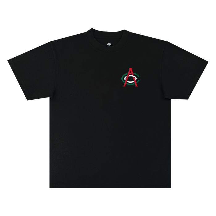 The OAC Viva OAC Tee is a black, short-sleeve classic fit t-shirt crafted from heavyweight cotton. It features a subtle design on the left chest: a small red “A” overlapping a green “C” inside a white oval—a nod to the Oakland Athletic Club—set against an otherwise plain black background, with no additional graphics or text.