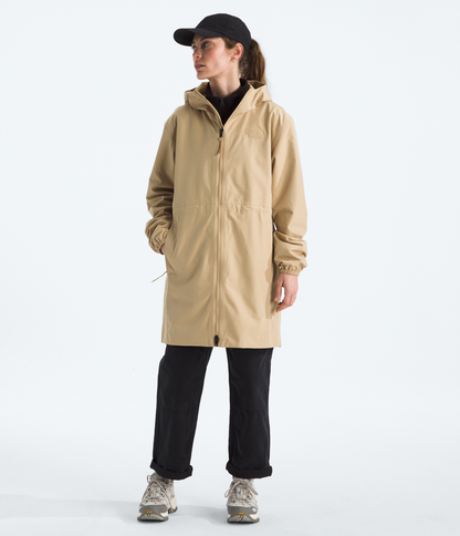 Person wearing a beige raincoat on a white background