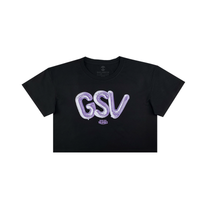 The Women’s Golden State Valkyries Balloons Crop Tee by GSV is a black cropped t-shirt with bold, shiny purple “GSV” balloon letters and a small white “VLVT STUDIOS” logo beneath, inspired by the Golden State Valkyries.