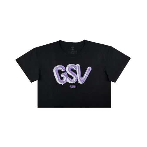 The Women’s Golden State Valkyries Balloons Crop Tee by GSV is a black cropped t-shirt with bold, shiny purple “GSV” balloon letters and a small white “VLVT STUDIOS” logo beneath, inspired by the Golden State Valkyries.